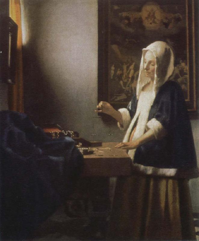 Jan Vermeer woman holding a balance